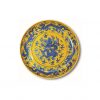 a blue and white dragon dish on yellow ground